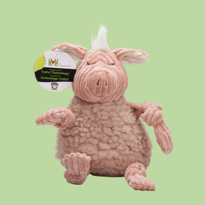 Plush pig toy with a tag on a green background