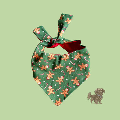 Green dog bandana with gingerbread man pattern on a light green background