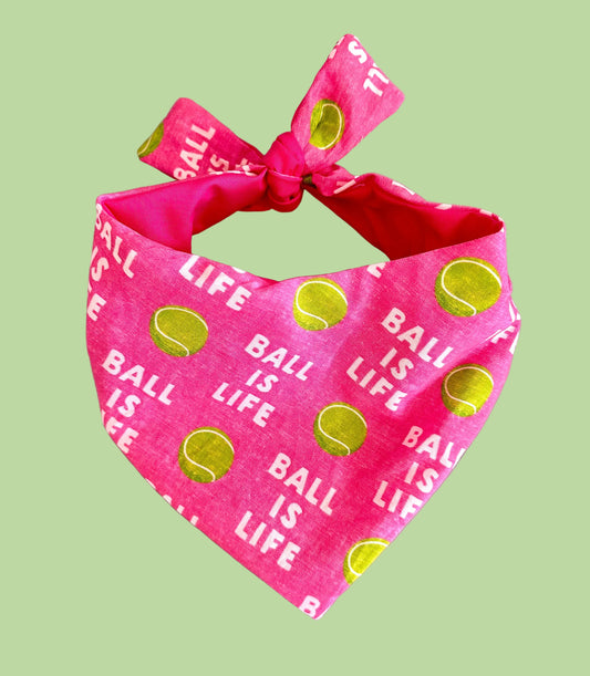Pink bandana with 'Ball is Life' text and tennis ball graphics on a gray background